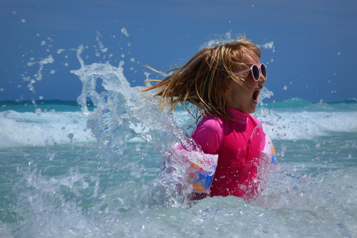 Girl enjoying the waves on a family summer vacation